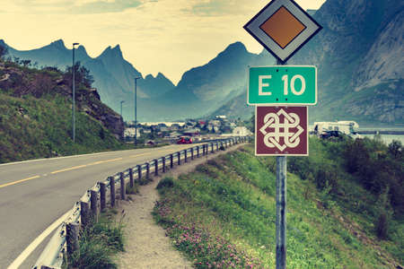 Signs on national tourist road 10 and fjord landscape, Reine village, Lofoten islands, North Norway....