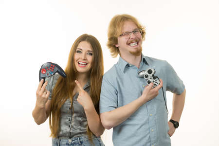 Happy couple enjoying leisure time by playing video games together. Studio shot isolated