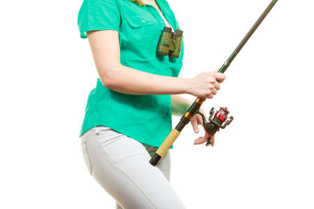 Fishery, spinning equipment, angling sport and activity concept. Woman with fishing rod.の写真素材