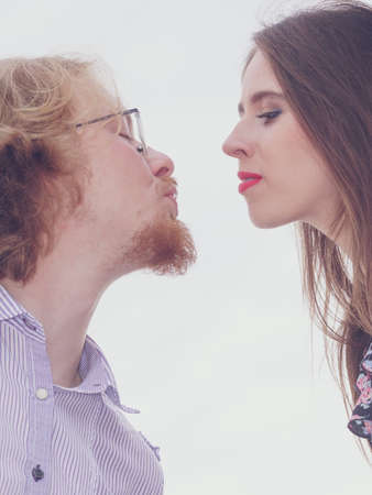 Vintage retro couple, man and woman enjoying their romantic date outside wearing fedora hats.の写真素材