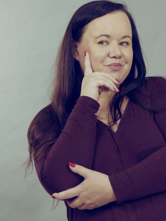 Thinking adult woman, plus size female gesturing with hands seeking for solution, having...