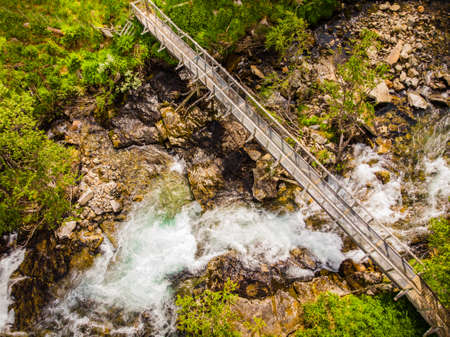 Fast flowing water river. Mountain region between Aurland and Laerdal in Norway. National tourist scenic route Aurlandsfjellet.の写真素材