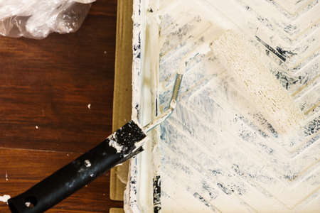 Home renovation, walls color change, diy concept. White paint with essentials equipment.