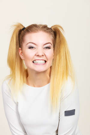 Education, teenage adolescence, happiness concept. Happy blonde teenager student girl with ponytails