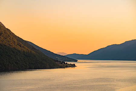 Norwegian landscape. Mountains hills and fjord at sunsetの写真素材