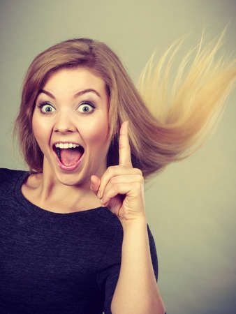 Happiness face expressions concept. Portrait of happy cheerful blonde woman smiling with joy having an ideaの写真素材