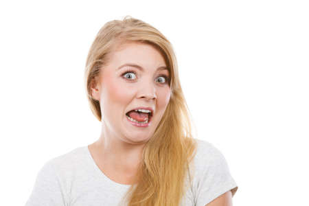 Fooling around, making silly faces concept. Blonde woman having tongue in clothespin