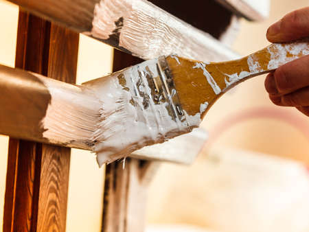 Home decor, color change, diy concept. Person renovating hanger made of wood.の写真素材