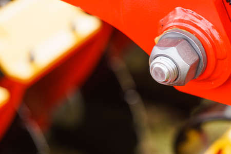 Construction machines concept. Detailed closeup of screw and bolts on indrustrial machineryの写真素材