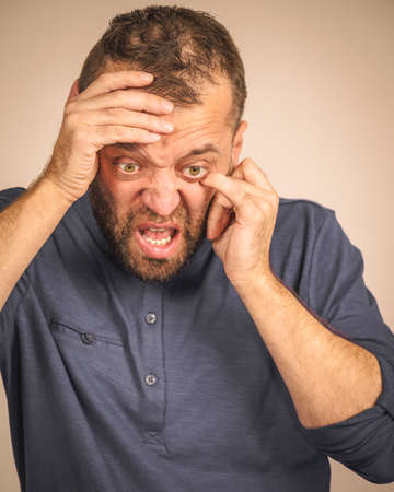 Furious bearded adult man, guy acting crazy being mad having mental crisisの写真素材