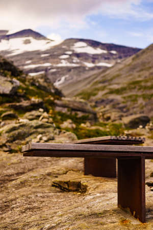 View of scenic mountains from Trollstigen viewpoint rest area with bench in Norway Europe, popular tourist attraction.の写真素材