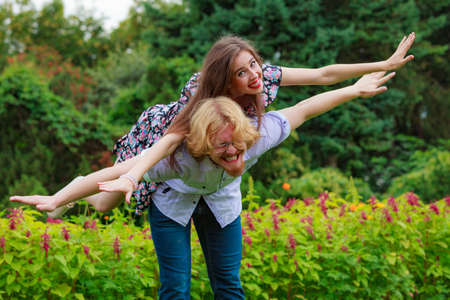 Happy couple having fun together outdoor. Happiness, great relationship. Man and woman fooling around in park.の写真素材