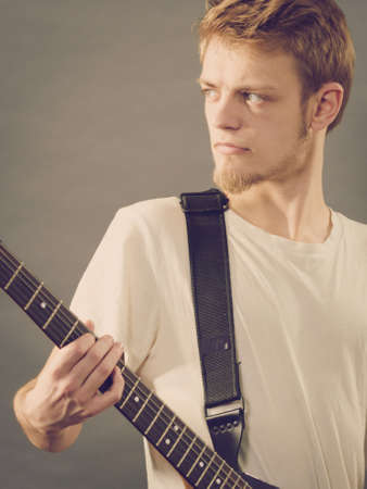 Man playing on electric guitar during gig. Musical instrument. Teenage boy having music hobby.