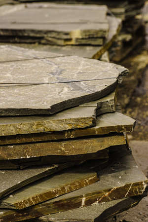 Stone masonry material on construction site. Industrial cobblestones for paving terrace, road or...