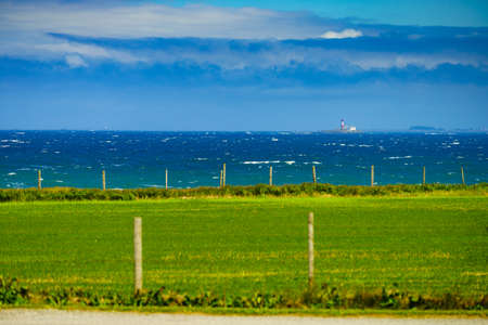 Coastal landscape with lighthouse in south Norway, Norwegian national tourist county route road 44 Jaeren.の写真素材