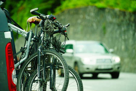 LATEFOSSEN, NORWAY - JUNE 24, 2018: Bicycles loaded on the back of van. Car is transporting bikes on rack.のeditorial素材