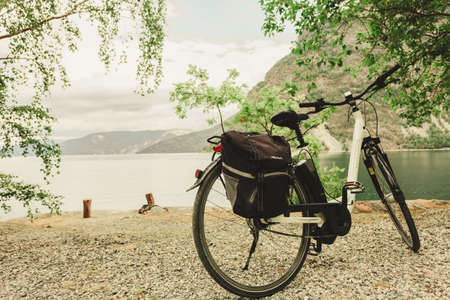 ERDAL, NORWAY - JUNE 28, 2018: Bicycle Kalkhoff brand on fjord shore Byfjorden in norwegian village Erdal. Kalkhoff is German bicycle manufacturer based in Cloppenburg.のeditorial素材