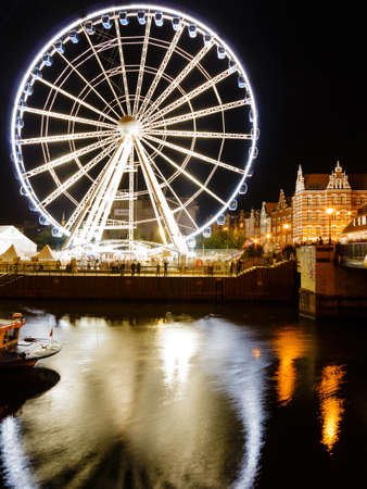 GDANSK, POLAND - AUGUST 16, 2014: Ferris wheel in Gdansk at night on August 16, 2014. A 55 meters high Ferris Wheel was launched in Gdansk Old Town, for the beginning of 754th street Dominik's Fair.のeditorial素材