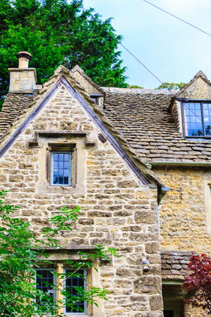 BIBURY, ENGLAND, UK - SEPTEMBER 21, 2014: Traditional Cotswold cottages in Gloucestershire on September 21, 2014, England. Bibury it the most depicted village in the world.のeditorial素材