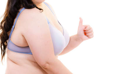 Plus size fat mature woman wearing bra lingerie giving thumb up, on white. Happy body positive female. Love yourself, no fatphobia.の写真素材