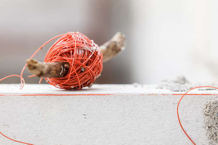 String net on wooden stick. Tool to help you set straight distances, spirit level.の写真素材