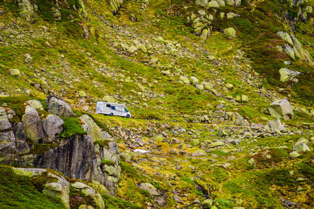 Camper car on road in green summer norwegian mountains. Travel in motor home, holidays and adventure concept.の写真素材
