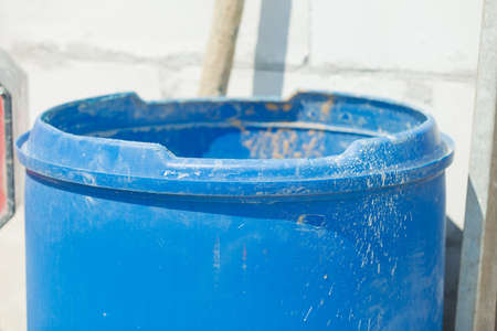 Plastic made blue dirty big bucket on construction site. Industrial objects details.の写真素材