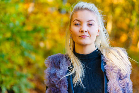 Long hair blonde young woman portrait outdoor at sunny autumnal dayの写真素材