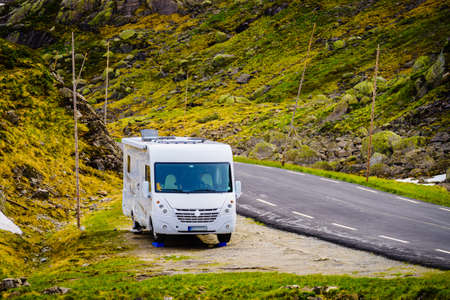 Camper car in green summer norwegian mountains. Travel in motor home, holidays and adventure concept.の写真素材