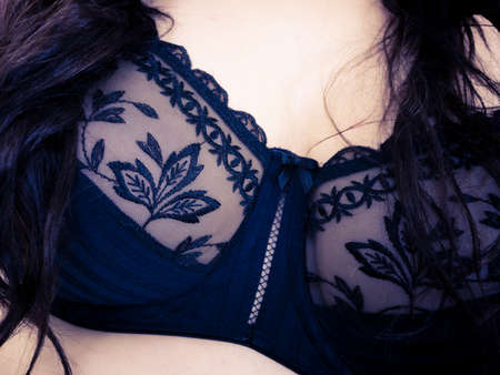 Plus size fat woman wearing black lace soft bra. Female breast in lingerie. Bosom, brafitting and underwear concept.の写真素材