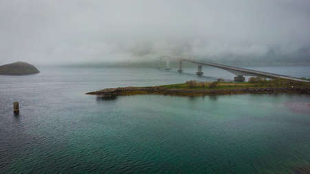 Aerial view. Bridge over fjord on Lofoten islands. Summer time, foggy hazy day, overcast weather.