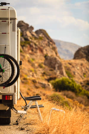 Tourism vacation and travel. Camper van with bicyles and camping furnitures on nature in Greeceの写真素材