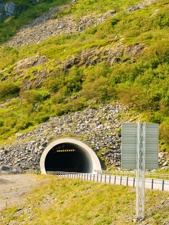 Road with tunnel in green summer mountains, Lofoten Norwayの写真素材