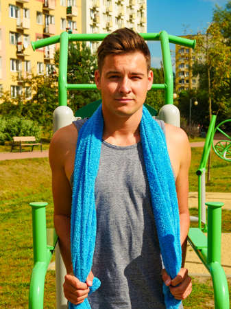 Handsome guy relaxing after outdoor workout. Fit man feeling healthy enjoying sun