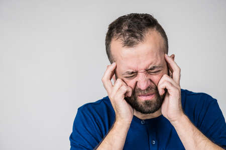 Adult man being worried about something. Guy gesturing with hands seeing unpleasand bad effects.