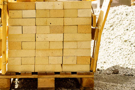 Brick on wooden palette, building material on construction site. Industry
