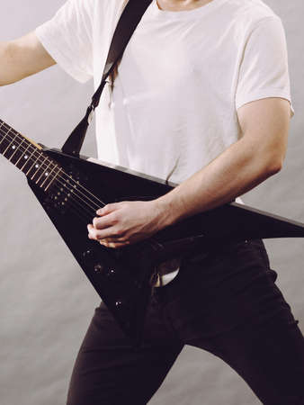 Man playing on electric guitar during gig. Musical instrument. Teenage boy having music hobby.の写真素材