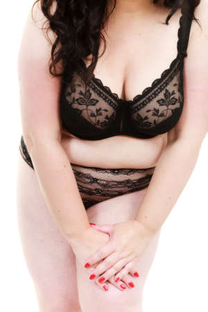 Plus size fat mature body, unrecognizable woman wearing black lace soft bra. Female breast in lingerie. Bosom, brafitting and underwear concept.の写真素材