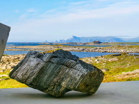 Seascape on Andoya island. Scenic rocky coastline with mountain peaks in distance, view from...