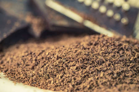 Grater, grated chocolate and chips curls closeup.の写真素材