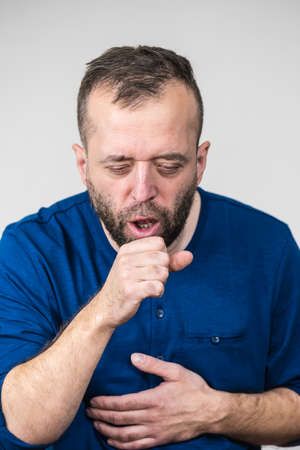 Adult bearded man having flu coughing with sore throat hurt. Guy choking.の写真素材