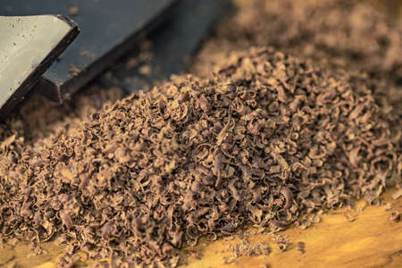 Heap of dark grated chocolate chips curls closeup.の写真素材