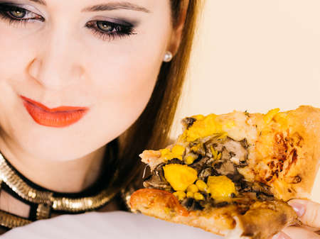Young woman eating hot fresh pizza slice. Delicious fast food meal. People, italian cuisine concept.の写真素材