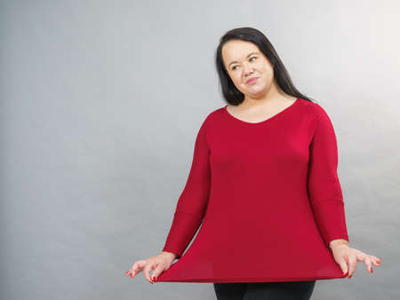 Curvy big woman covering her hips belly with plus size cotton elastic top tunic.