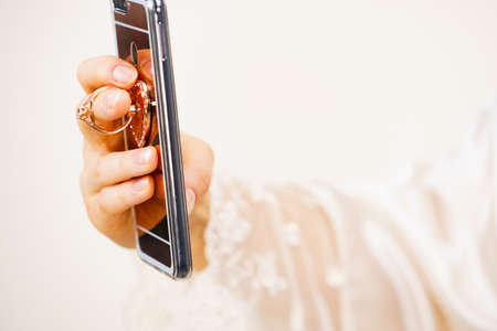 Technology and communication. Woman using mobile phone taking selfie photoの写真素材