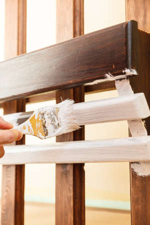 Home decor, color change, diy concept. Person renovating hanger made of wood.の写真素材