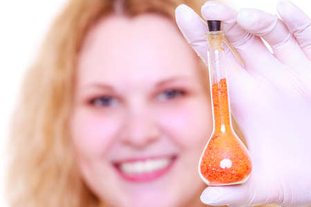 Chemist woman, girl student, female laboratory assistant or scientific researcher with chemical glassware test flask. Experiment, research in progress.の写真素材