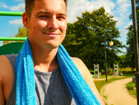 Handsome guy relaxing after outdoor workout. Fit man feeling healthy enjoying sunの写真素材