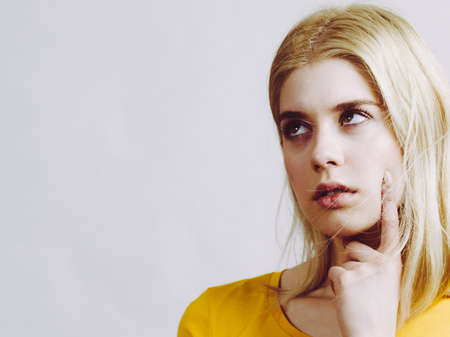 Young woman confused thinking seeks solution. Pensive thoughtful student girl coming up with an...