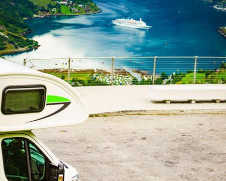 Camper car on Flydasjuvet viewpoint and fjord Geirangerfjord with cruise ship, Norway. Travel...